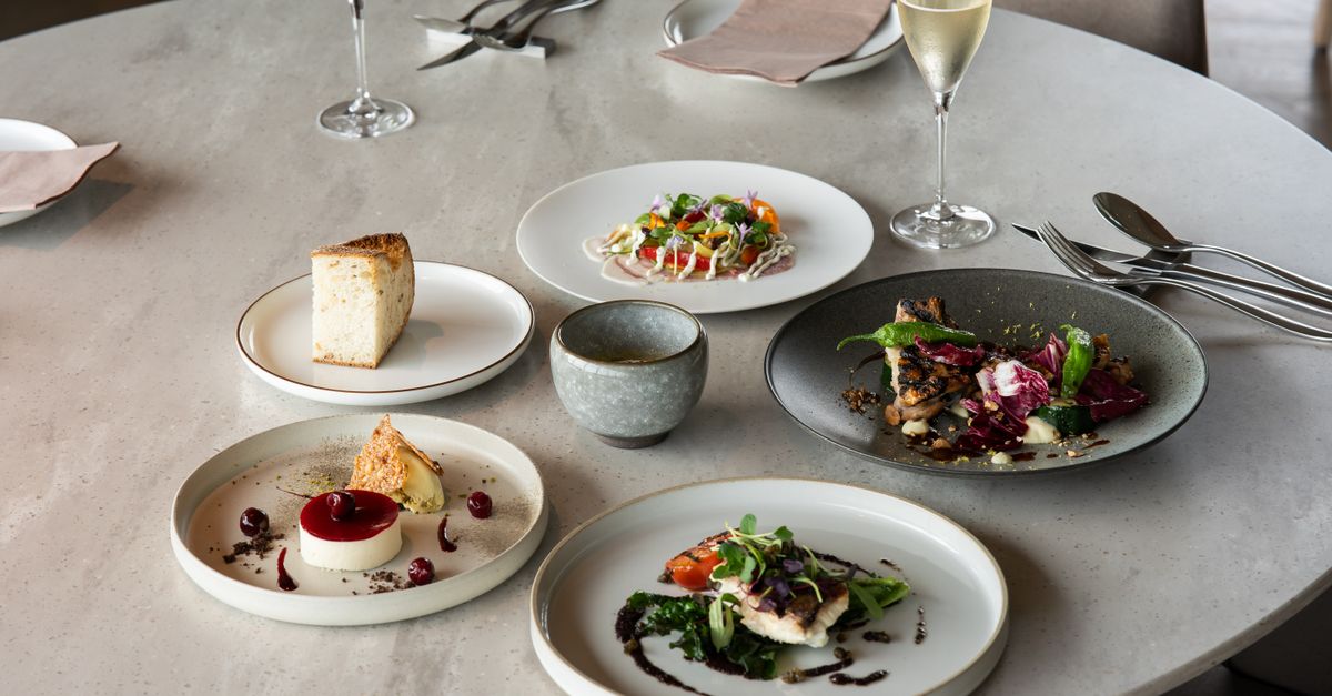 Elegant fine dining setup with gourmet dishes and wine in Tokyo, Japan.